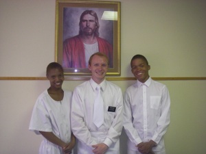 Tshedi Seathlodi with Elder Payne and Elder Willombe on her baptism day.