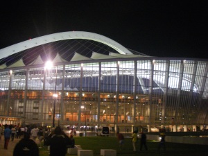 The soccer stadium at night, lit up for the big game!